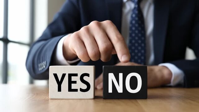 Businessman Deciding Yes or No - Close-up of a businessman's hand choosing between two blocks reading "YES" and "NO," signifying a critical decision-making process.