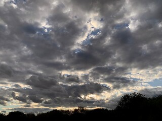 Cloudy sky at sunset, rays of light breaking through the clouds.