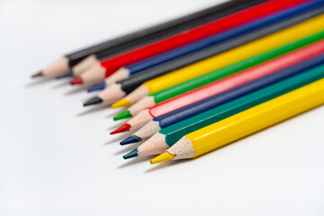 Many colorful pencils on white background. Colored pencils for drawing, many colors, on a white background