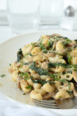 Pasta with mushrooms, spinach, and parmesan cheese. Close-up.