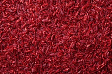 Naklejka premium Uncooked red wild rice spread out, aerial perspective