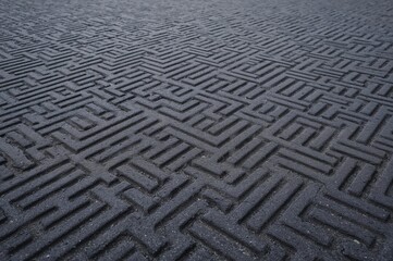 Close-up view of a textured rubber hydro pad crafted from recycled automobile tires, ideal for innovative urban surfaces and recreational areas.