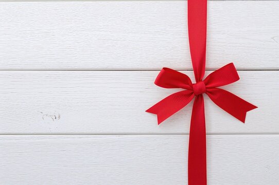 Bundle of noodles tied with a crimson ribbon on a plain backdrop, culinary theme, classic style, wooden surface, cooking area, dining spot, recipe card