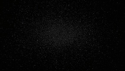 Sunlight illuminating dust specks on a dark computer display, creating a pattern of scattered white dots against a black backdrop.