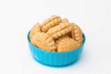 Blue bowl filled with puff pastry palmiers on plain white surface