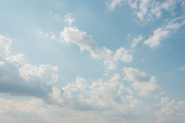 Wide-angle shot capturing a bright, windy sky with blue hues, resembling a cloudy day in spring or summer.