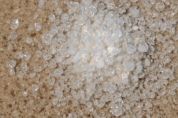 Sodium benzoate, a frequent preservative in sour food products, is commonly found in powdered or granular form in beverages like soft drinks and fruit juices.
