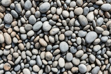Close-up of smooth, rounded stones surface. Detailed pebbles texture. High-resolution image.