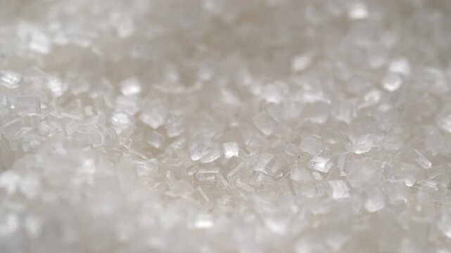 Macro video of sugar particles. close up texture of white sugar.