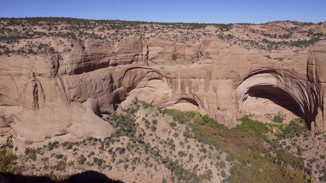 Navajo National Monument in Navajo Nation territory, Arizona. Betatakin ruins in Betatakin Canyon with autumn aspen. One of three well-preserved cliff dwellings of the Ancestral Puebloan people.