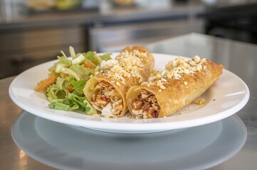 A pair of rolled tortilla snacks served on a dish, traditional cuisine