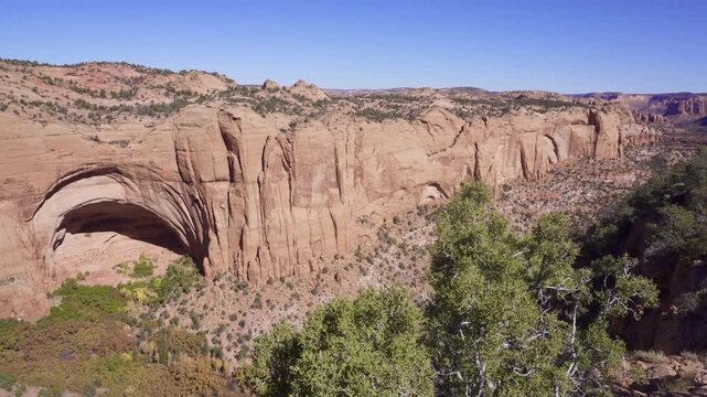 Navajo National Monument in Navajo Nation territory, Arizona. Betatakin ruins in Betatakin Canyon with autumn aspen. One of three well-preserved cliff dwellings of the Ancestral Puebloan people.
