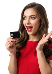 Naklejka premium Young caucasian woman, early 20s, long wavy brown hair, red lipstick, red top, holds black credit card, right hand open in surprise on transparent studio background, concept of financial success