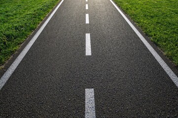Sunlight highlights white lines on the park's pavement