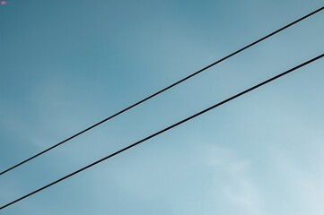 Close-up of electrical cables against the sky backdrop