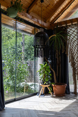 rustic greenhouse living room with tropical foliage for concepts of comfort  serenity and eco-friendly interior