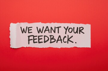 Your feedback note on torn paper with a red backdrop. Conceptual feedback icon. Empty space.