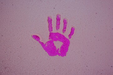 Vibrant handprint art on a colorful sandy shore as a striking wallpaper backdrop. Artistic photography with an abstract natural theme for design, banners, and posters.