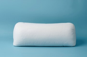 Obraz premium Blue backdrop featuring a white bolster cushion