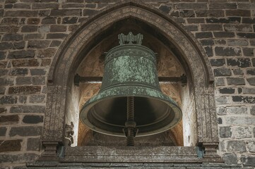 Obraz premium Ancient bell tower ruins with stunning lighting on historic stone architecture, featuring gothic religious symbols and an industrial ambiance