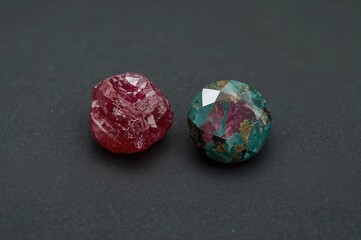 Raw Ruby and Zoisite Displayed on a Black Surface