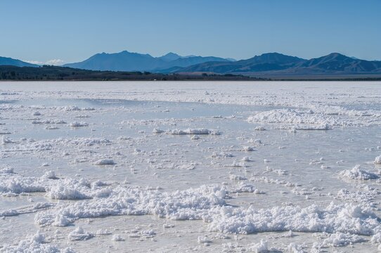 Salt flats with water and natural landscape featuring white and blue hues