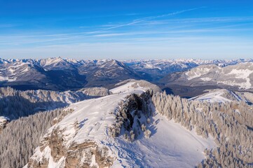 Winter panorama of snowy mountain peaks under a clear blue sky