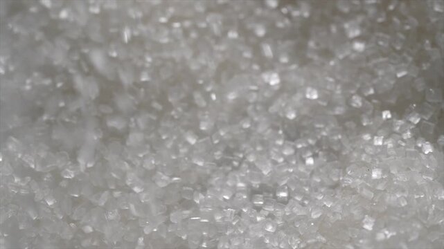 Macro video of white sugar particles. Close up texture of sugar.