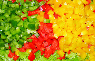 Freshly chopped green, red, and yellow bell peppers
