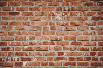 Fototapeta premium Weathered brick surface with cracked cement texture