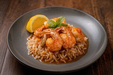 Fototapeta premium Spicy seafood fried rice featuring shrimp and squid on a gray dish