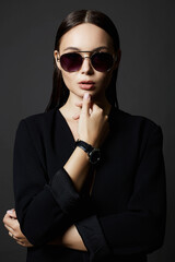 beauty girl in trendy glasses and black suit