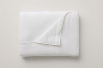 Overhead view of a neatly folded white bath towel
