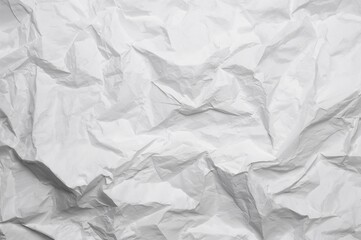 Close-up view of wrinkled paper texture on a white surface