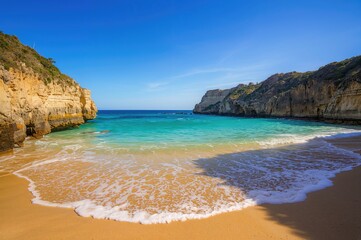 Naklejka premium A serene landscape featuring transparent blue waters softly touching warm sandy shores, bordered by rocky cliffs. The atmosphere is calm under a bright blue sky, with just the gentle sound of waves.