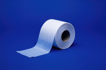 Roll of toilet tissue on a bright blue background