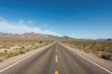 Fototapeta premium Endless highway stretching through vast arid mountain terrain