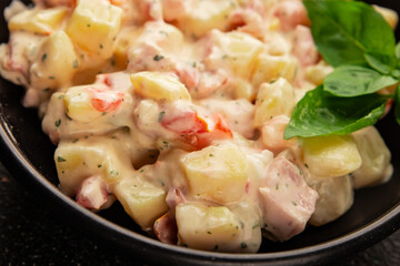 Potato salad ham, potato, tomato, carrot, mayonnaise tasty snack fresh delicious gourmet food background on the table rustic top view copy space
