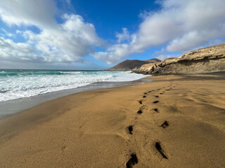Footprints on the golden sand at La Solapa Beach, Fuerteventura