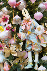 Luxurious rabbit doll in Rococo-style clothing, surrounded by pink ornaments and golden florals in a dreamy woodland Christmas tree setting