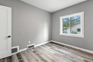Bedroom with a white door and a window