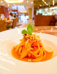 Close-up of papaya salad on a plate in a restaurant