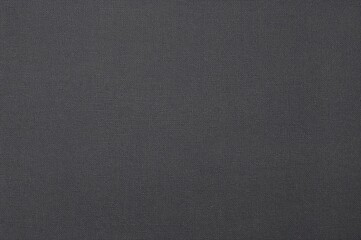 Synthetic polyester canvas texture for backgrounds. Dark polyester fabric textile backdrop ideal for interior design or text overlay.