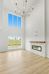 Large room with a fireplace and a chandelier