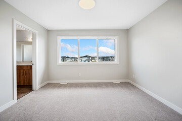 Large, empty room with a window overlooking a city