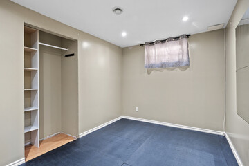 Small, empty room with a window and a closet