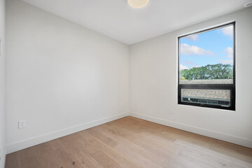 Very empty room with a large window