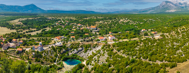 Cetina River spring Eye of the Earth near Church of Holy Salvation in Dalmatian Hinterland Croatia aerial panorama