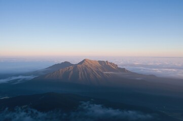 Sunrise over the peak surrounded by a blanket of fog