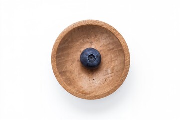 Wooden bowl filled with blueberries on a white surface. Overhead shot. Flat layout.